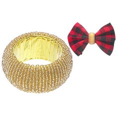 a red and black plaid bow tie next to a gold bangle bracelet on a white background