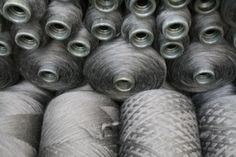 many balls of yarn are stacked on top of each other