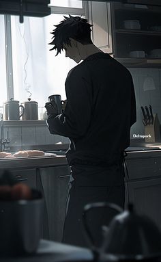 a man standing in a kitchen holding a coffee cup and looking at something on the counter