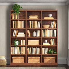 a bookshelf filled with lots of books and wicker baskets on top of it