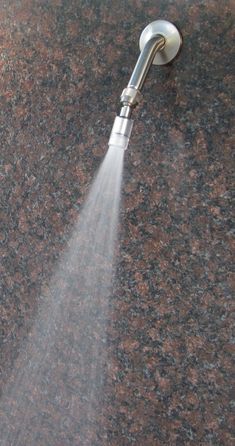 a faucet spewing water from it's side on a granite countertop