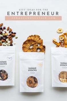 three bags filled with nuts and dried fruit on top of a white table next to each other