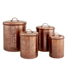 three copper canisters with ornate designs on them