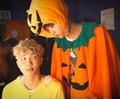 two young boys in halloween costumes standing next to each other