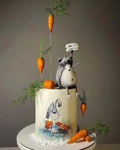 there is a cake with carrots on the top and an image of a raccoon