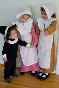 three children dressed in costumes standing next to each other