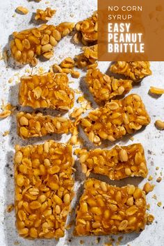 Peanut brittle without corn syrup broken into pieces on a white background.