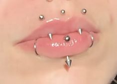 a woman with piercings on her mouth and tongue is shown in this image from the bottom