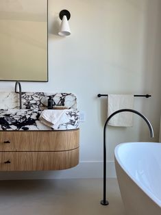 a bathroom with a sink, mirror and bathtub