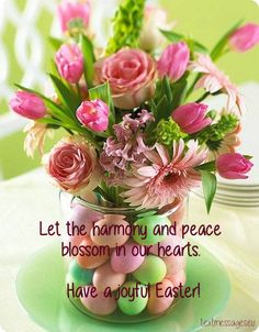 a vase filled with pink flowers sitting on top of a table next to a plate