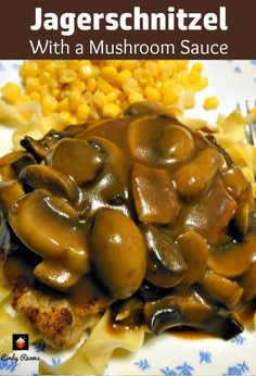 a plate topped with meat covered in mushroom sauce