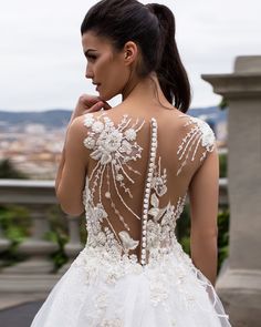 the back of a woman's dress with beading and pearls