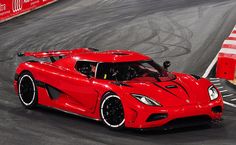 a red sports car driving on a race track