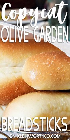 two loaves of bread sitting on top of a plate with the words copycat olive garden