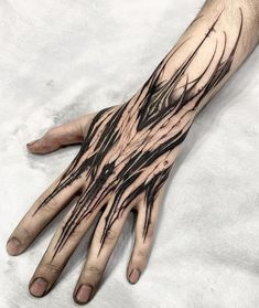 a man's hand with black ink on it and lines coming out of the palm