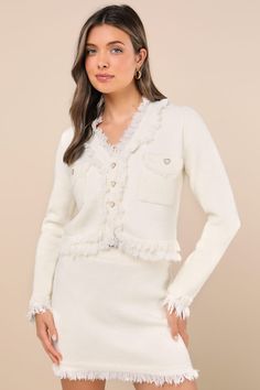 Let's take a moment to admire how adorable the Lulus Pristine and Pretty Ivory Fringe Two-Piece Sweater Mini Dress is! Sparkly, silver tinsel-like threading adorns plush sweater knit as it shapes a lightly cropped top with a V-neckline and long sleeves. Twin flap pockets and a functional button placket accent the bodice with pearly heart-shaped buttons in textured gold settings. Matching skirt has a ribbed knit, elasticized waistband that tops a bodycon mini skirt. Fun layers of fluffy fringe adorn the neckline, pockets, cuffs, and hems. Fit: This garment fits true to size. Length: Mid-thigh. Size medium Bust: Great for any cup size. Waist: Fitted - stretchy fabric allows custom fit. Hip: Fitted - stretchy fabric allows room for hips. Undergarments: May be worn with any standard bra. Fabri Fluffy Fringe, Sweater Mini Dress, Bodycon Mini Skirt, Silver Tinsel, Mini Sweater Dress, Sweater Knit, Cropped Top, Large Size Dresses, Stretchy Fabric