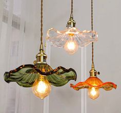 three light fixtures hanging from a ceiling in a room