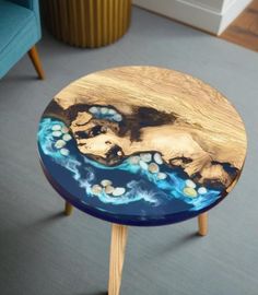 a wooden table sitting on top of a carpeted floor next to a blue couch