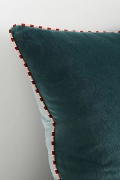 a green pillow sitting on top of a white wall