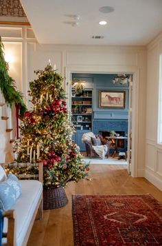 a living room with a christmas tree in the corner