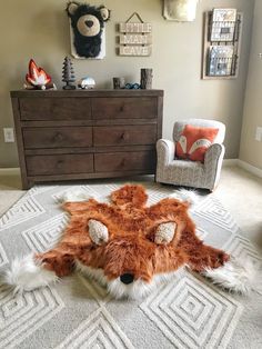 an animal rug is on the floor in a child's room with two chairs and a dresser