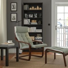 a living room with a chair and ottoman