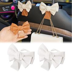 two bows are attached to the handle of a purse in a car, and one is being held by a woman's hand