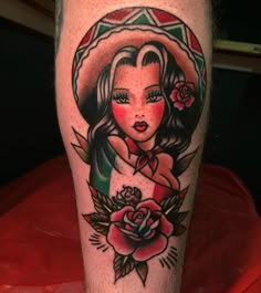 a woman's leg with a tattoo on it and a rose in the center