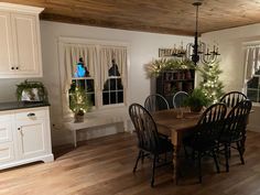 a dining room table and chairs with christmas decorations