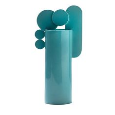 a tall blue vase with two small round objects in it