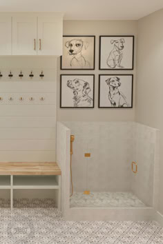 a bathroom with pictures on the wall and a bench in front of it next to a shower