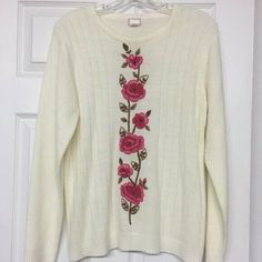 GORGEOUS cream color crew neck sweater with ribbed pattern.  Stunning pink flowers / roses down the front.  Flowers have beaded centers. 100% acrylic. Armpit to armpit measures approximately 21".   Great gently used condition. Pink Flowers Roses, Color Crew, Cream Sweater, Crew Neck Sweater, Cream Color, Neck Sweater, Pink Flowers, Needlework, Tunic Tops