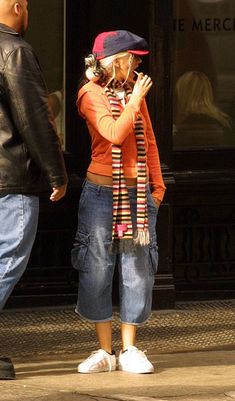 a woman standing next to a man on the street