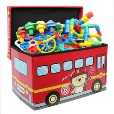 a red toy box filled with lots of toys and magnets on top of it