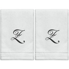 two towels with the letter f in black ink on white linen, one is folded and the other has a monogrammed design