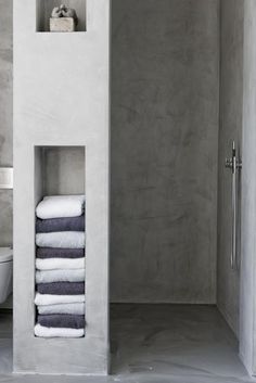 three pictures of towels stacked on top of each other in the same room, one is white and the other is gray