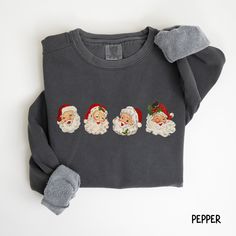 an ugly sweater with santa's faces on it