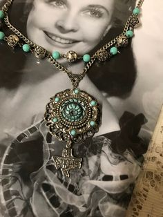 This is a handcrafted upscaled vintage assemblage necklace.  It features a filigree turquoise and silvertone pendant with a rose in center.  I added a tiny Texas charm at the bottom of the pendant .  It has a silvertone chain and I added some Turquoise and silvertone beads as an accent.  No returns.  Ship to continental US only. Cadiz, Mixed Media Art, Vintage Assemblage Necklace, Jewelry Repurposed, Vintage Jewelry Repurposed, Vintage Assemblage, Assemblage Necklace, Art Mixed Media, Altered Art