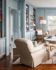 a living room filled with furniture and blue walls