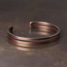 Hand-crafted double banded oxidised pure copper bangle for men. Material: Copper Width: 8mm / 0.3". Lengths: 15 to 18cm, 19 to 22cm / 5.9" to 7.1", 7.4" to 8.6". Adjustable. Adjustable Brown Copper Bangle, Brown Copper Bangle, Brown Copper Bracelet With Patina, Brown Copper Patina Bracelets, Bangle For Men, Camping Knots, Ring Pendant Necklace, Watch Necklace, Pure Copper