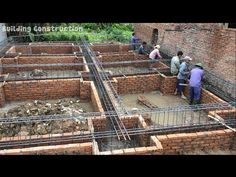 men are working on the foundation of a building with bricks and steel bars attached to it