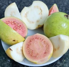 a white plate topped with pieces of fruit