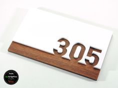 a wooden sign with the number 350 on it's front and back sides is shown