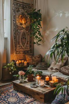 a living room filled with lots of plants and candles on top of a coffee table