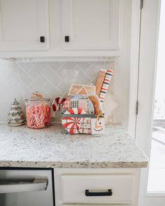 the kitchen counter is covered with candy and candies for christmas decorations, as well as other holiday treats