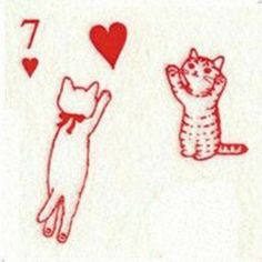 two cats playing cards with hearts and one cat jumping up to catch the ball in mid air