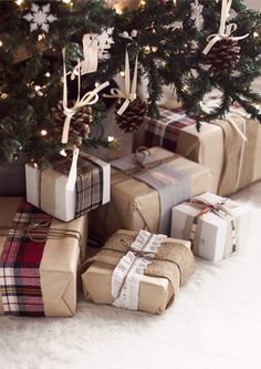 presents under the christmas tree are wrapped in brown paper