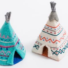 two small felt teepee houses sitting next to each other