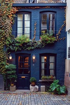 a blue house with ivy growing on it's side