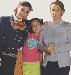 two women and a girl are posing for the camera